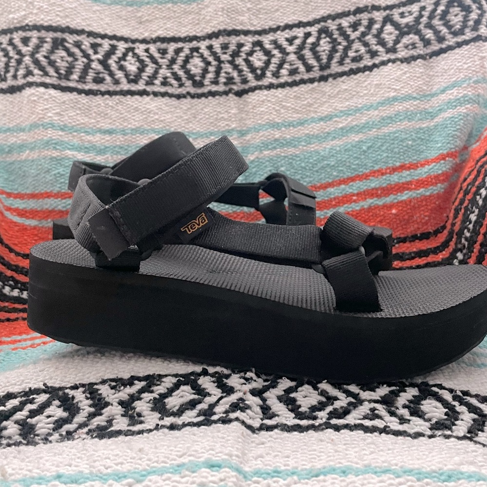Teva black flatform sandals.